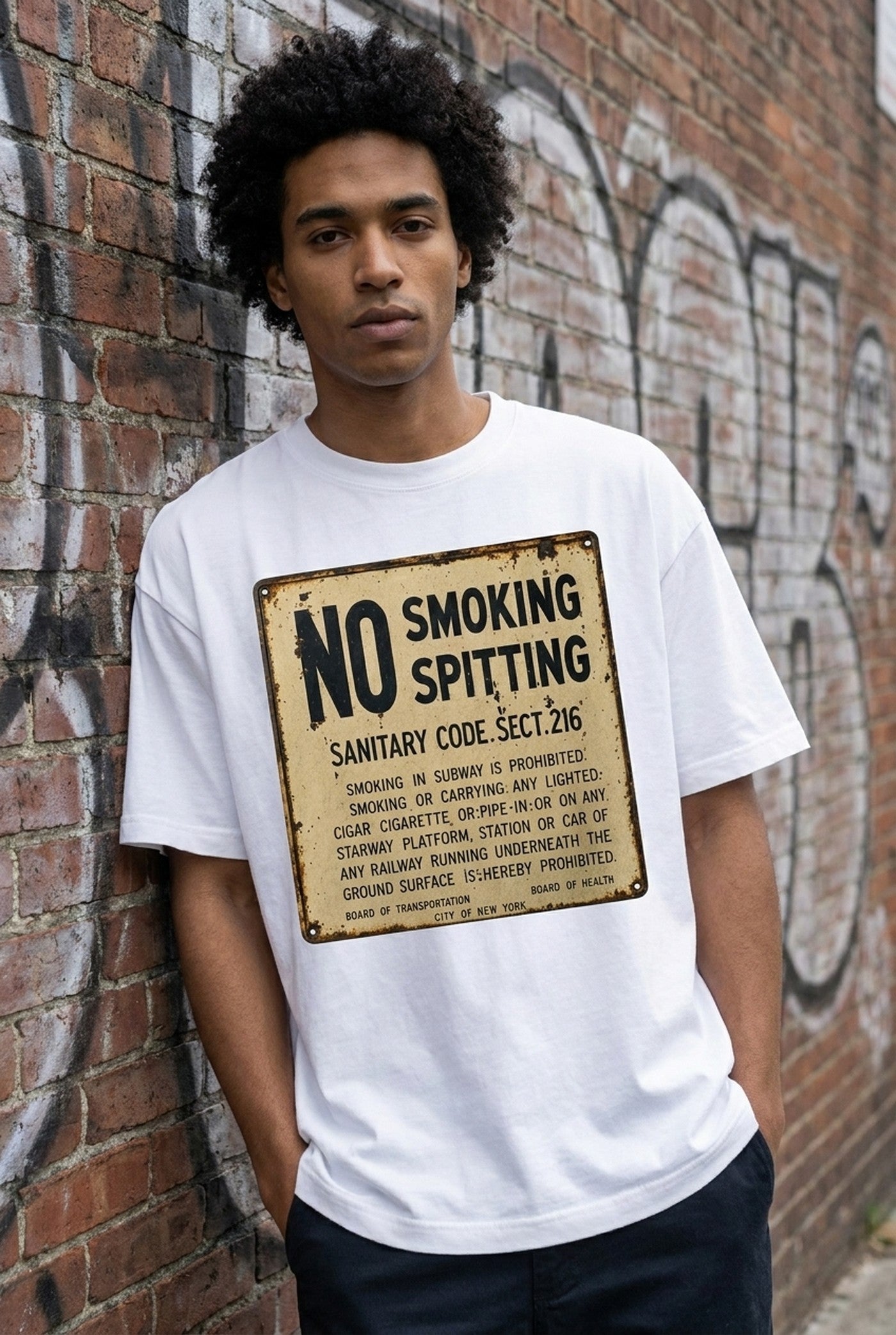 The Sanitary Code Tee on a model against an NYC brick wall