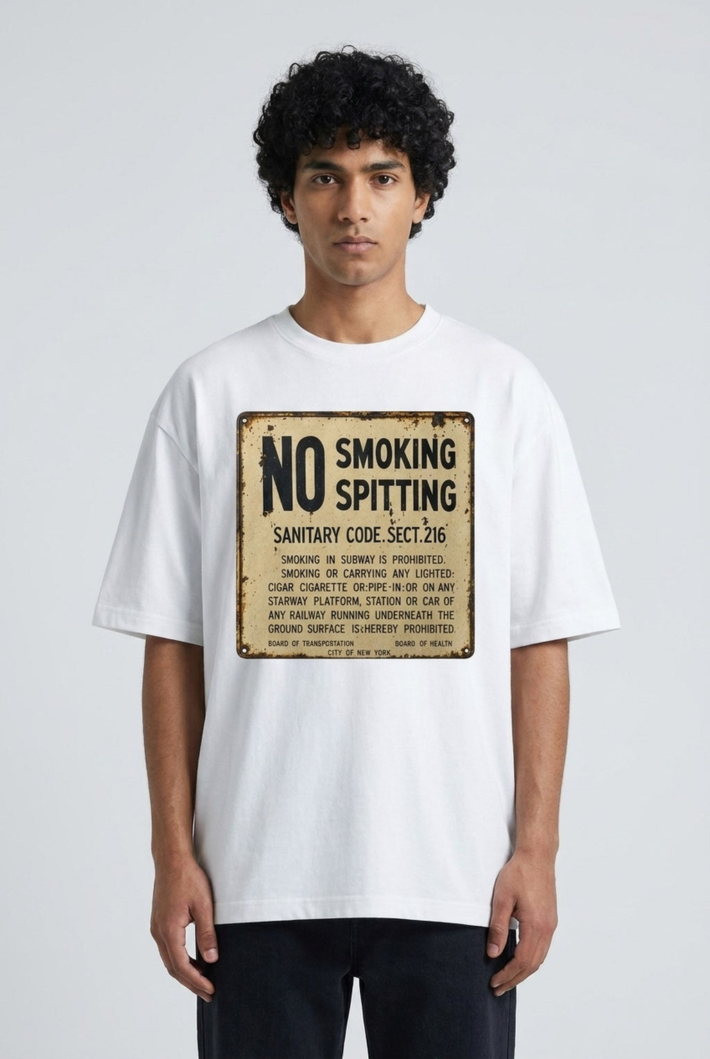The Sanitary Code Tee — vintage NYC No Smoking Spitting sign on a white tee, worn on a model