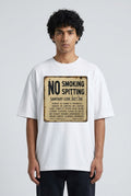 The Sanitary Code Tee — vintage NYC No Smoking Spitting sign on a white tee, worn on a model